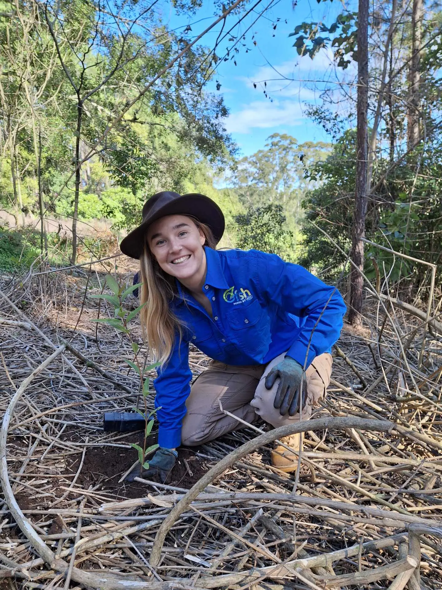 OzFish staff member Zoe White planting a tree