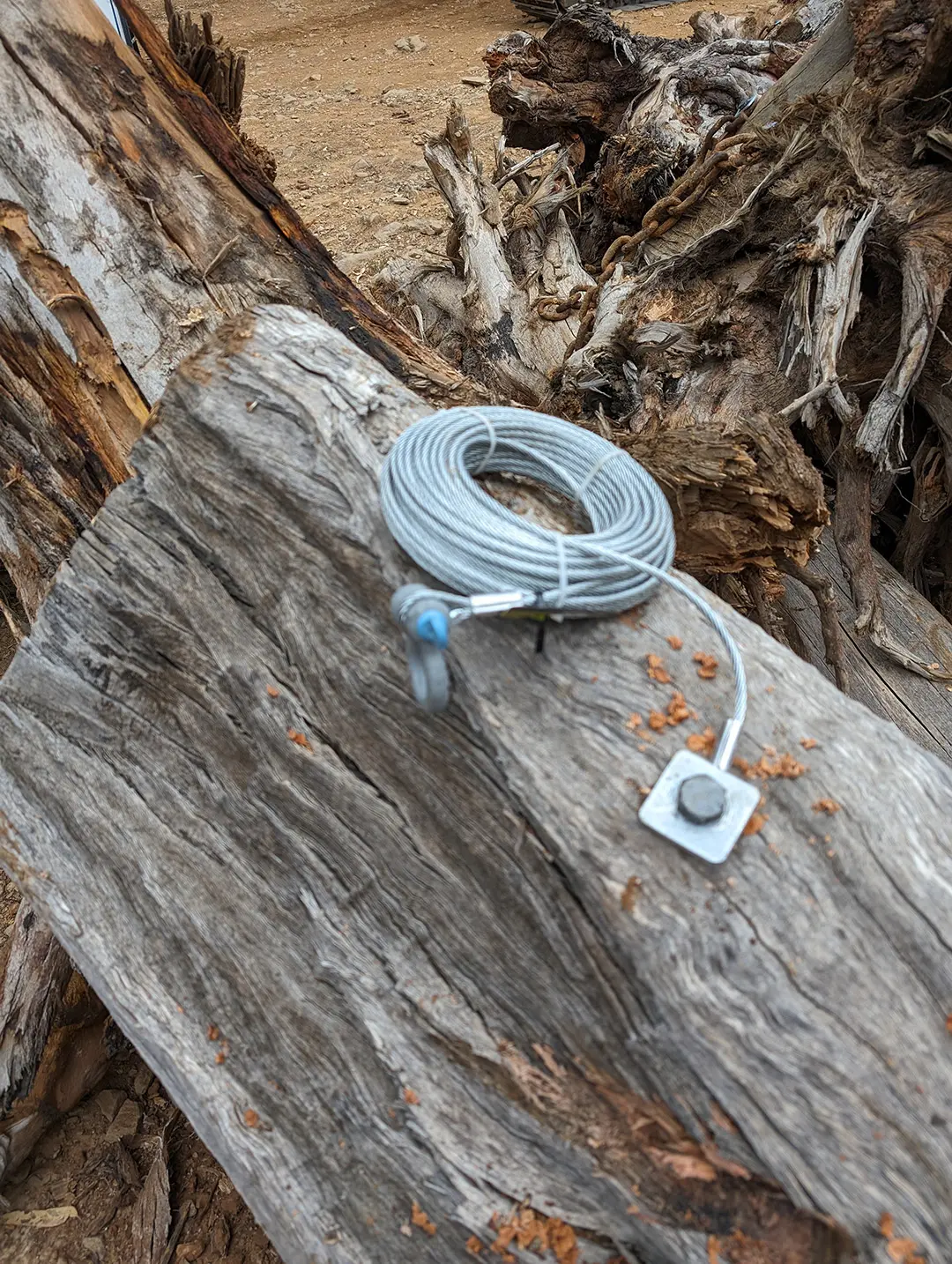 Wire connected to a big bit of log