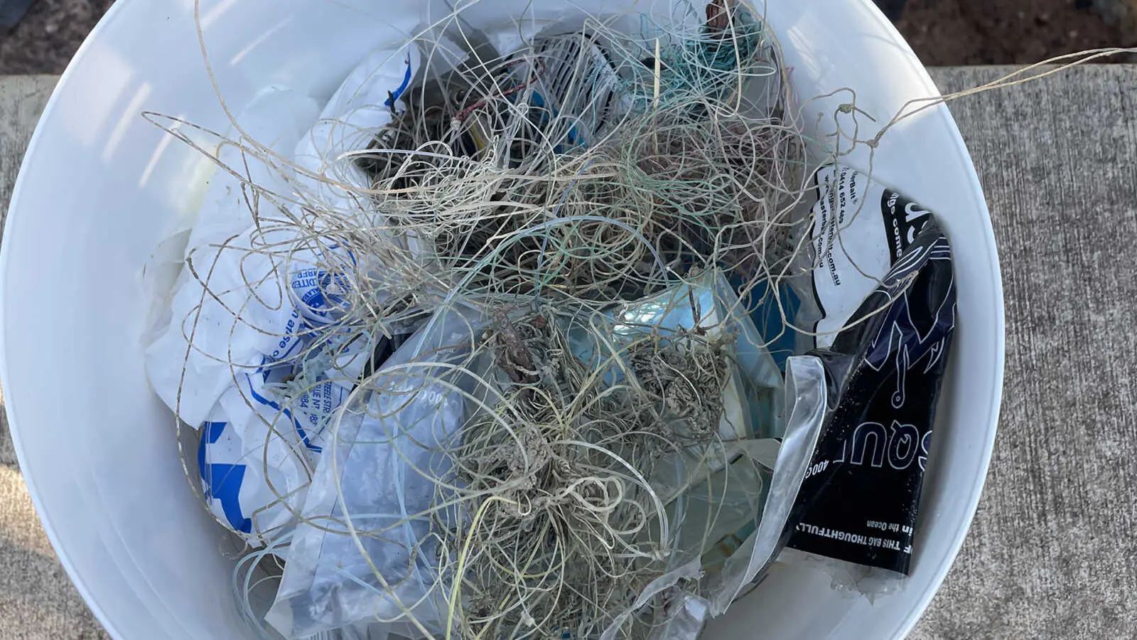 fishing line and other rubbish in a bucket