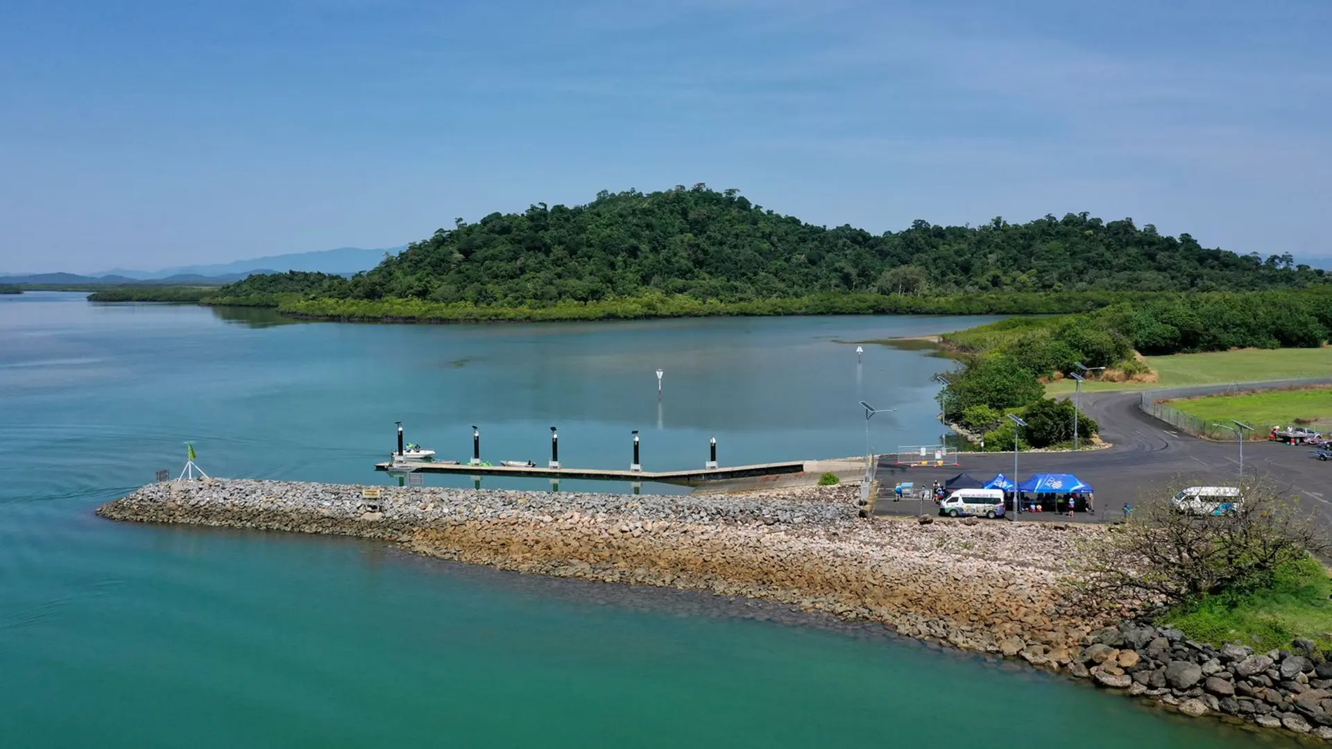 ariel view of a harbour with a rock jetty leading out into the water